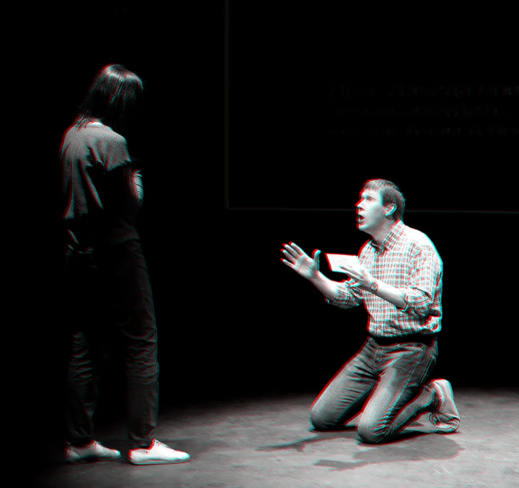 A participant kneels in the middle of a scene