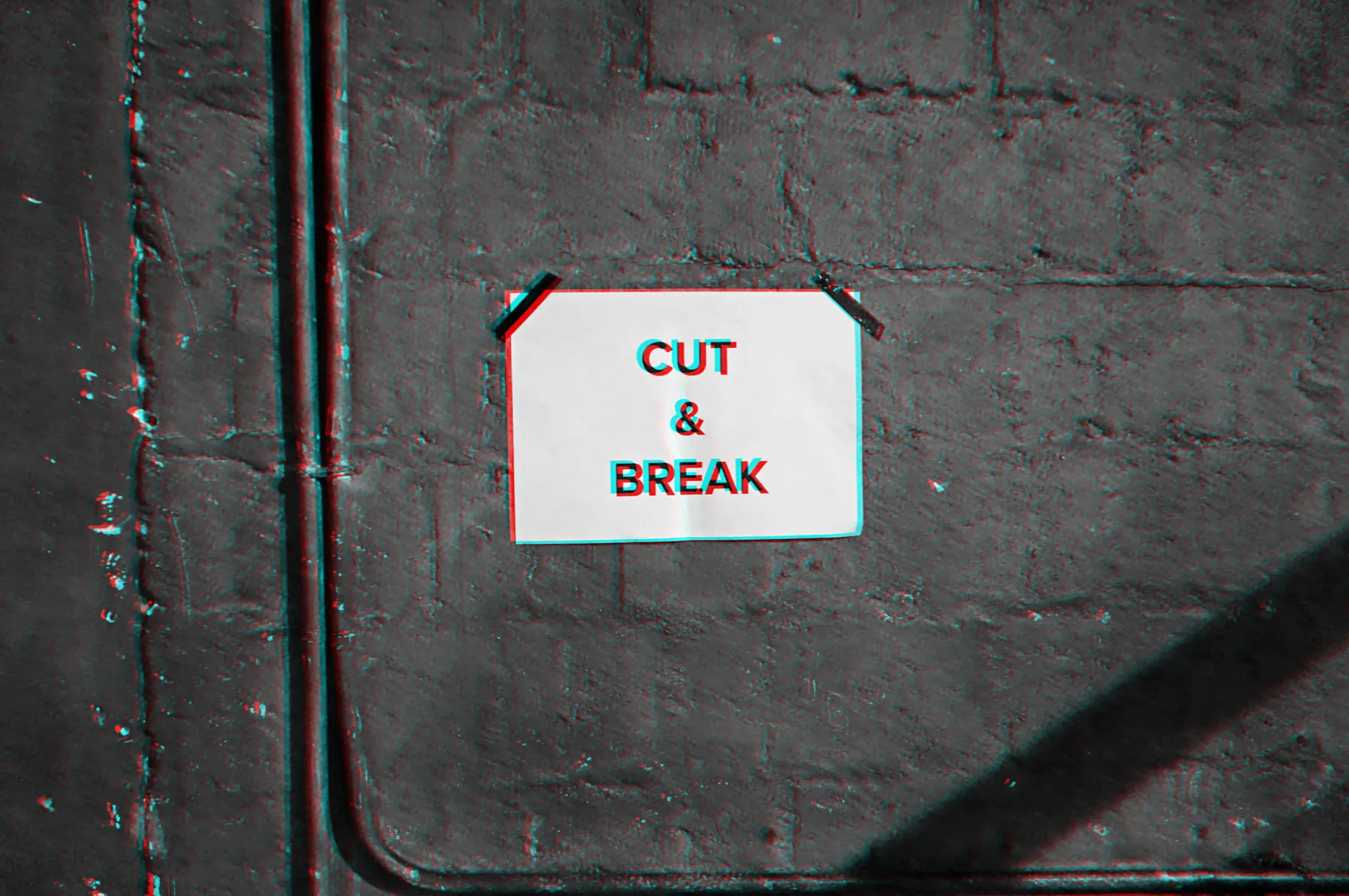 A “Cut & Break” sign taped to the wall