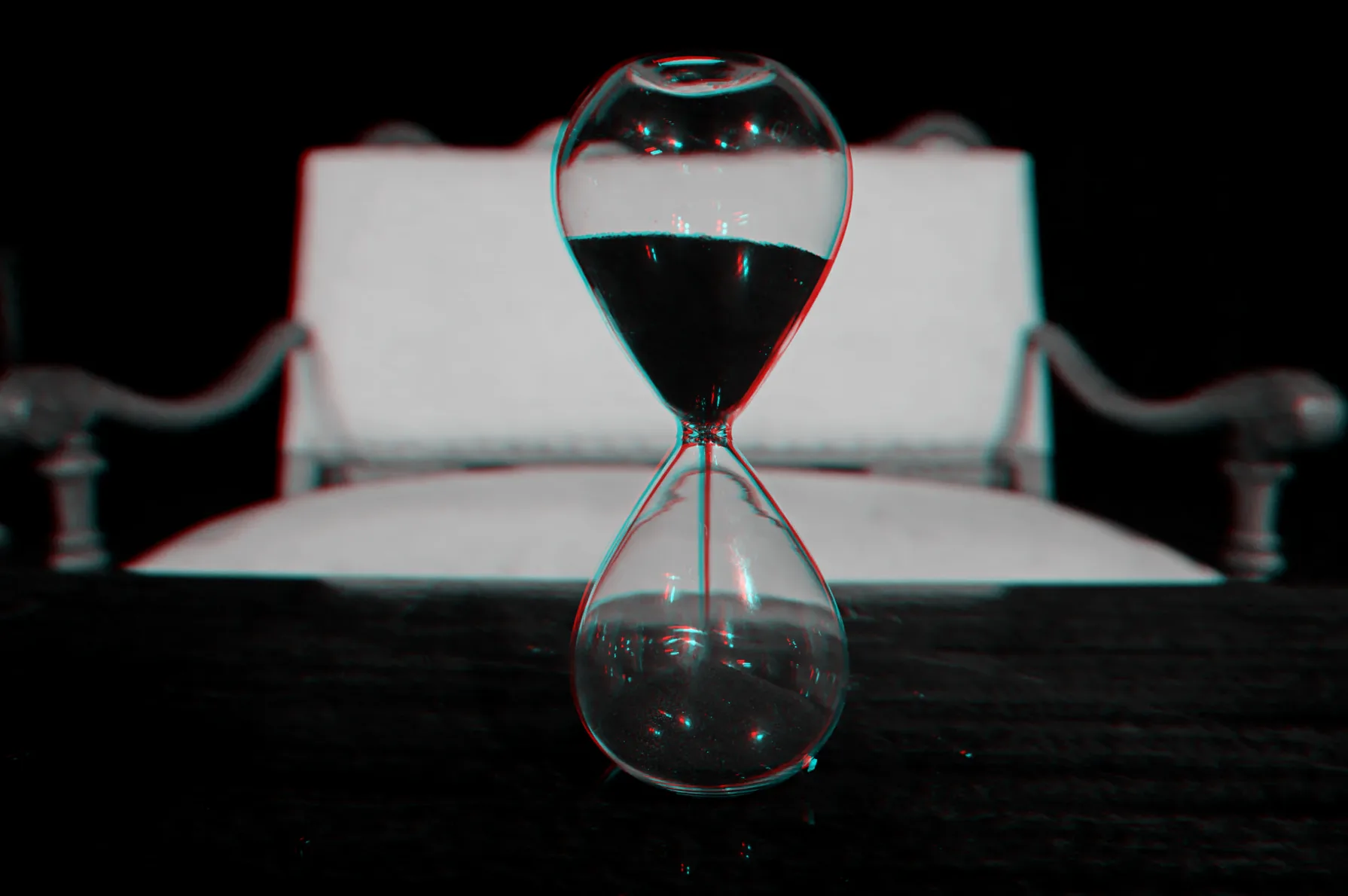 An hourglass in front of the sofa