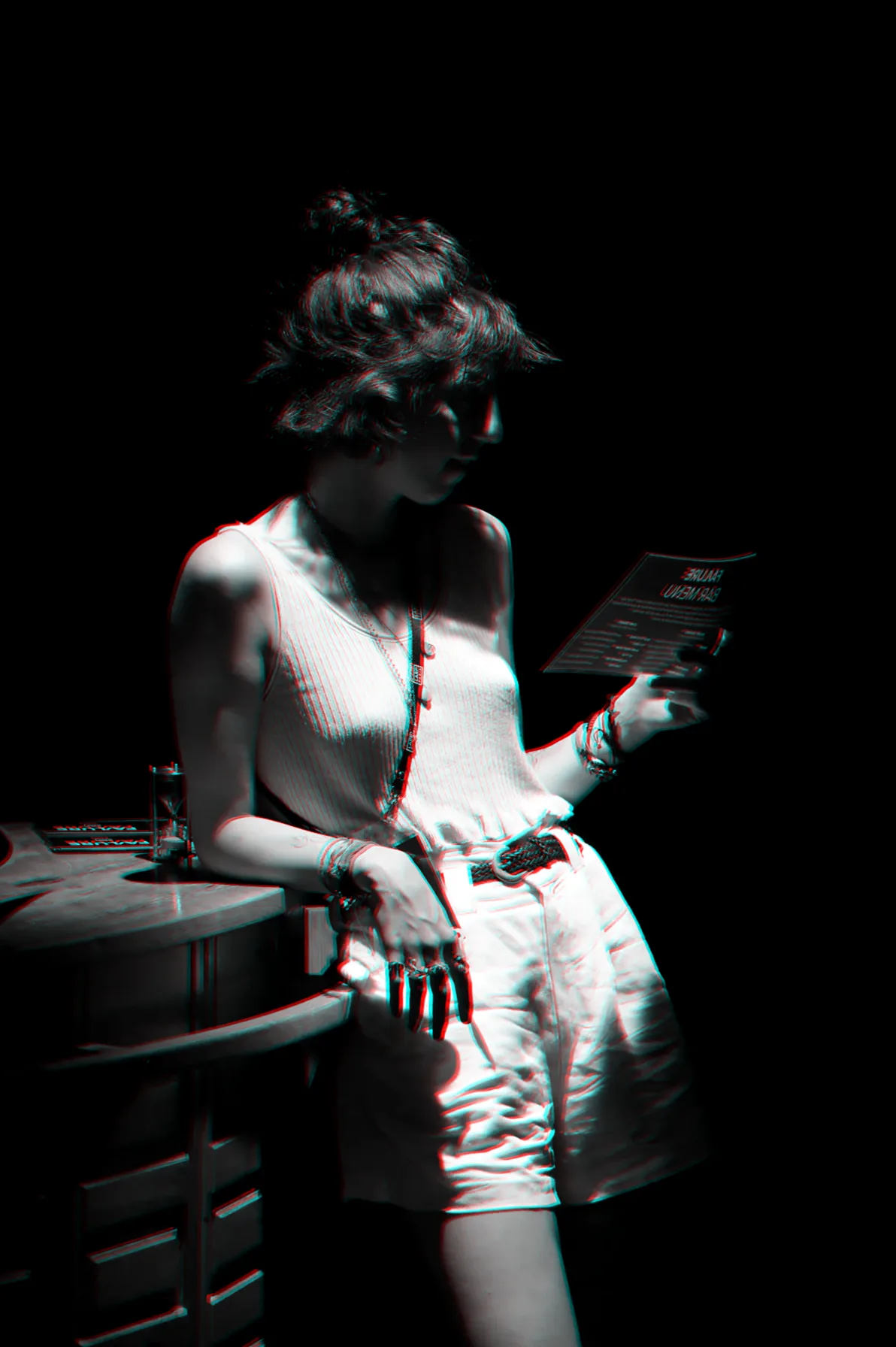 A participant reading her role by the cabinet