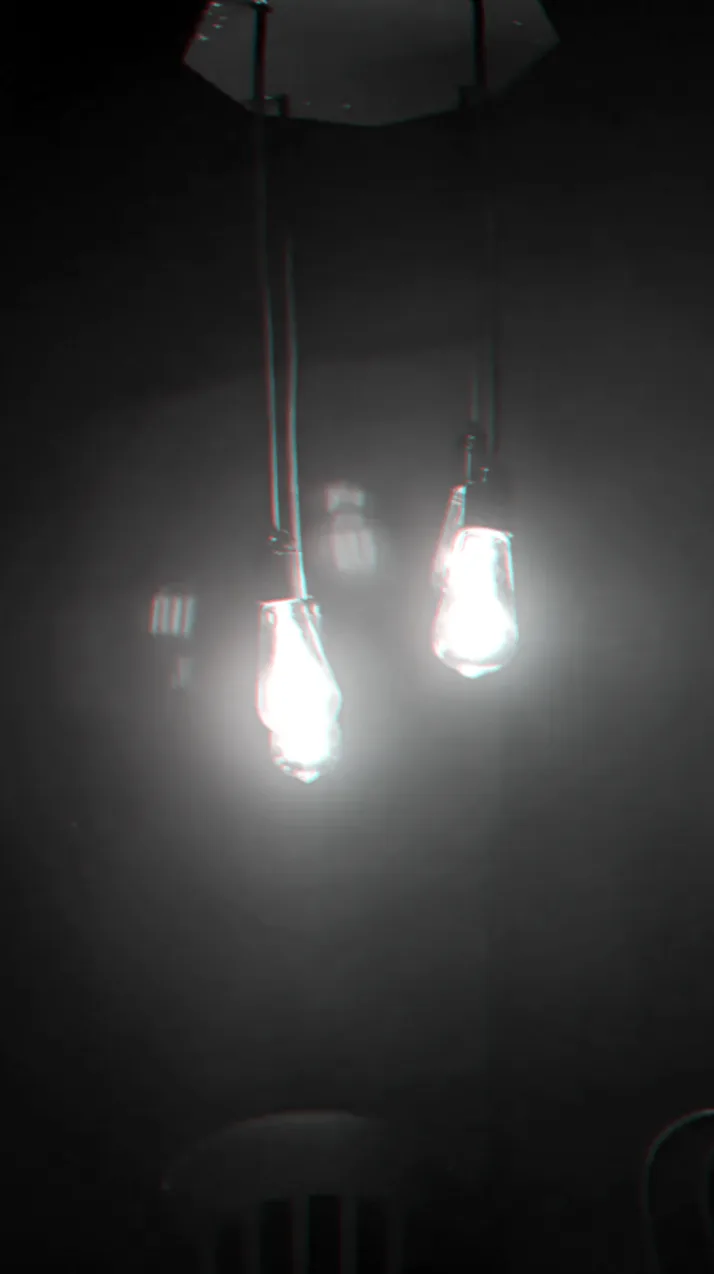 Two bare light bulbs hanging in the dark