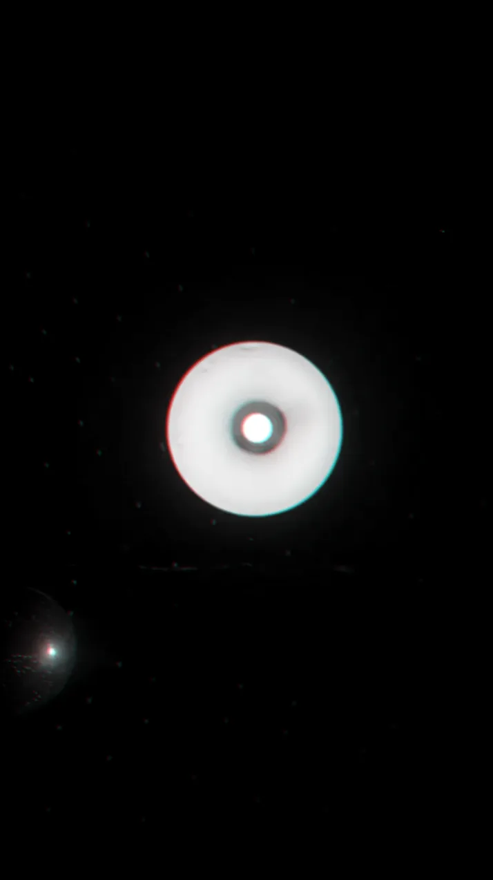 A glowing pink disc in a dark room