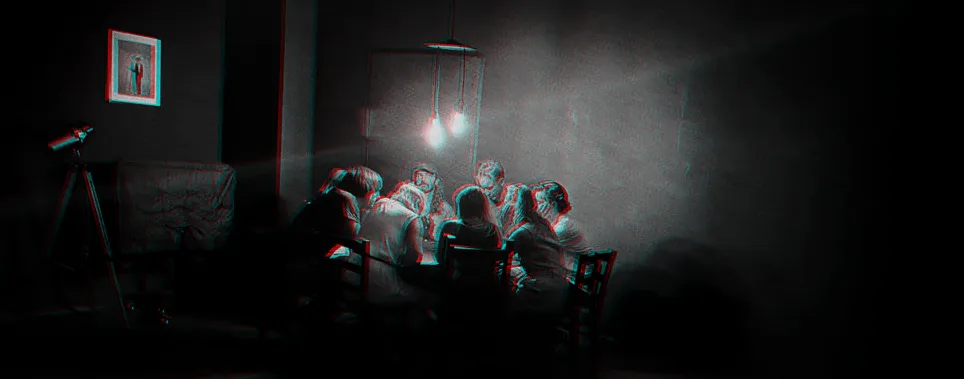 A group around a table under a warm lamp